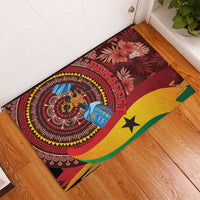Red rubber doormat corner view with circular figure, palm leaves, and yellow-green star.