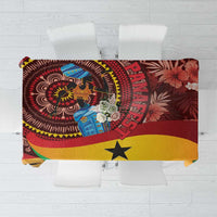 Red tablecloth with tropical Ghana-inspired pattern, central figure, yellow star accents.