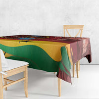Red tropical tablecloth draped over a rectangular dining table with green and yellow shapes.