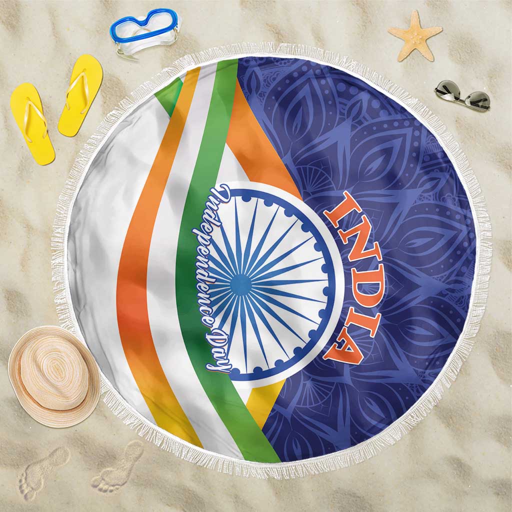 Round beach blanket with colorful diagonal stripes, blue-white emblem, and white fringe edge