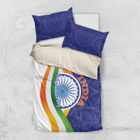 India-themed bedding set laid flat: blue paisley duvet with Ashoka emblem and tricolor stripe, shams