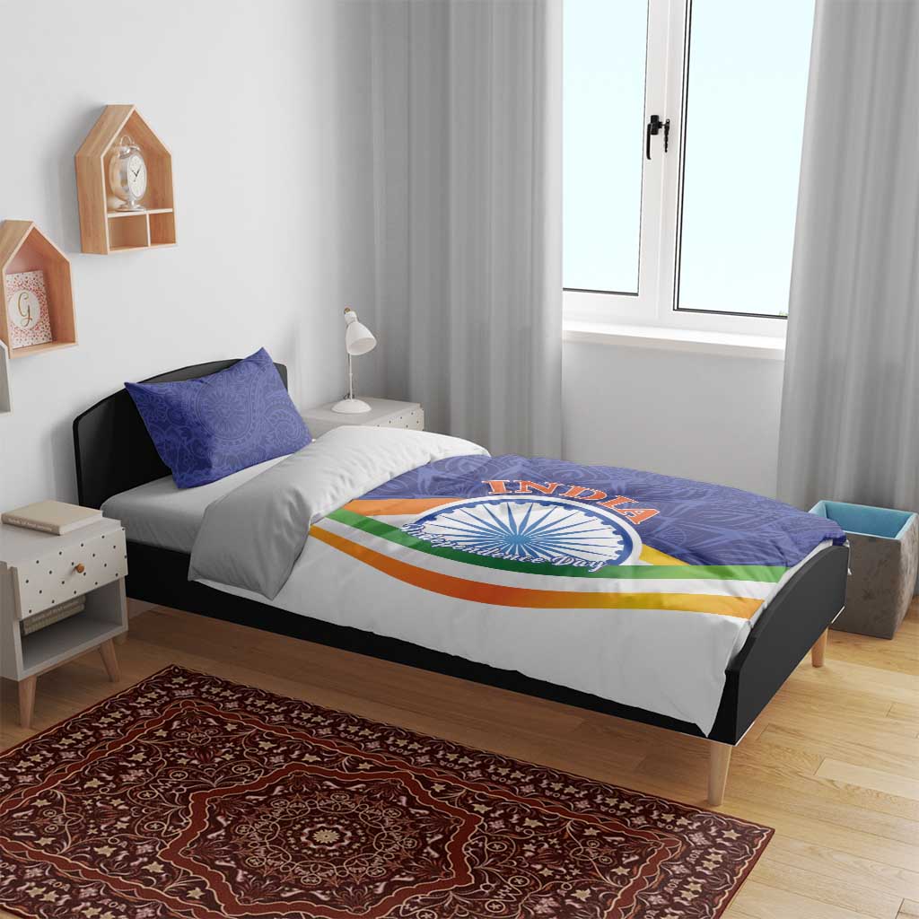 India-themed bedding set on bed: blue paisley duvet with Ashoka emblem, tricolor stripe pillow shams