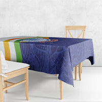 Blue paisley mandala tablecloth draped over table with tricolor border stripe