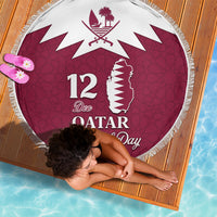 Round red beach blanket with white fringe, Qatar map graphic and "12 Dec Qatar"