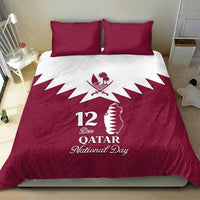 Red bedding set with two pillows; duvet shows white zigzag rays and “12 Dec Qatar” text