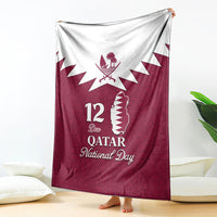 Red Qatar National Day blanket with white Qatar map, 12 Dec text, and emblem