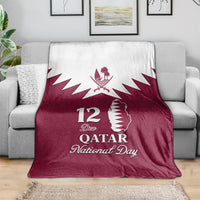 Red Qatar National Day blanket draped on sofa, white Qatar map and emblem, 12 Dec