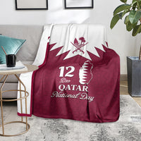 Red Qatar National Day blanket on chair, white Qatar map and 12 Dec National Day text