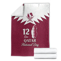 Folded red Qatar National Day blanket, white Qatar map, 12 Dec National Day emblem