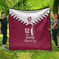 Red quilt blanket with white Qatar map emblem and “12 De Qatar National Day” lettering