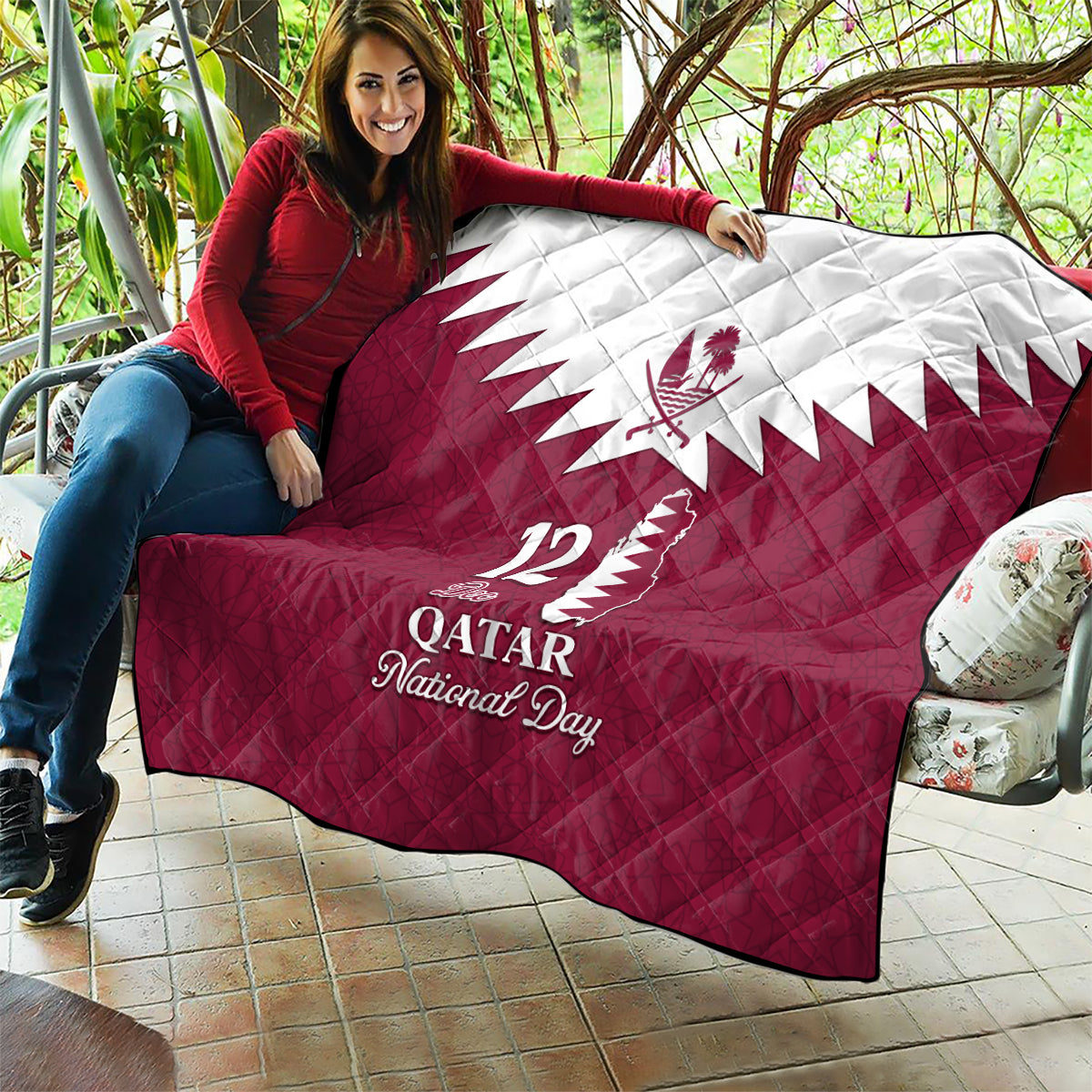 Red and white quilt blanket with white Qatar emblem, 12 De Qatar, and National Day lettering
