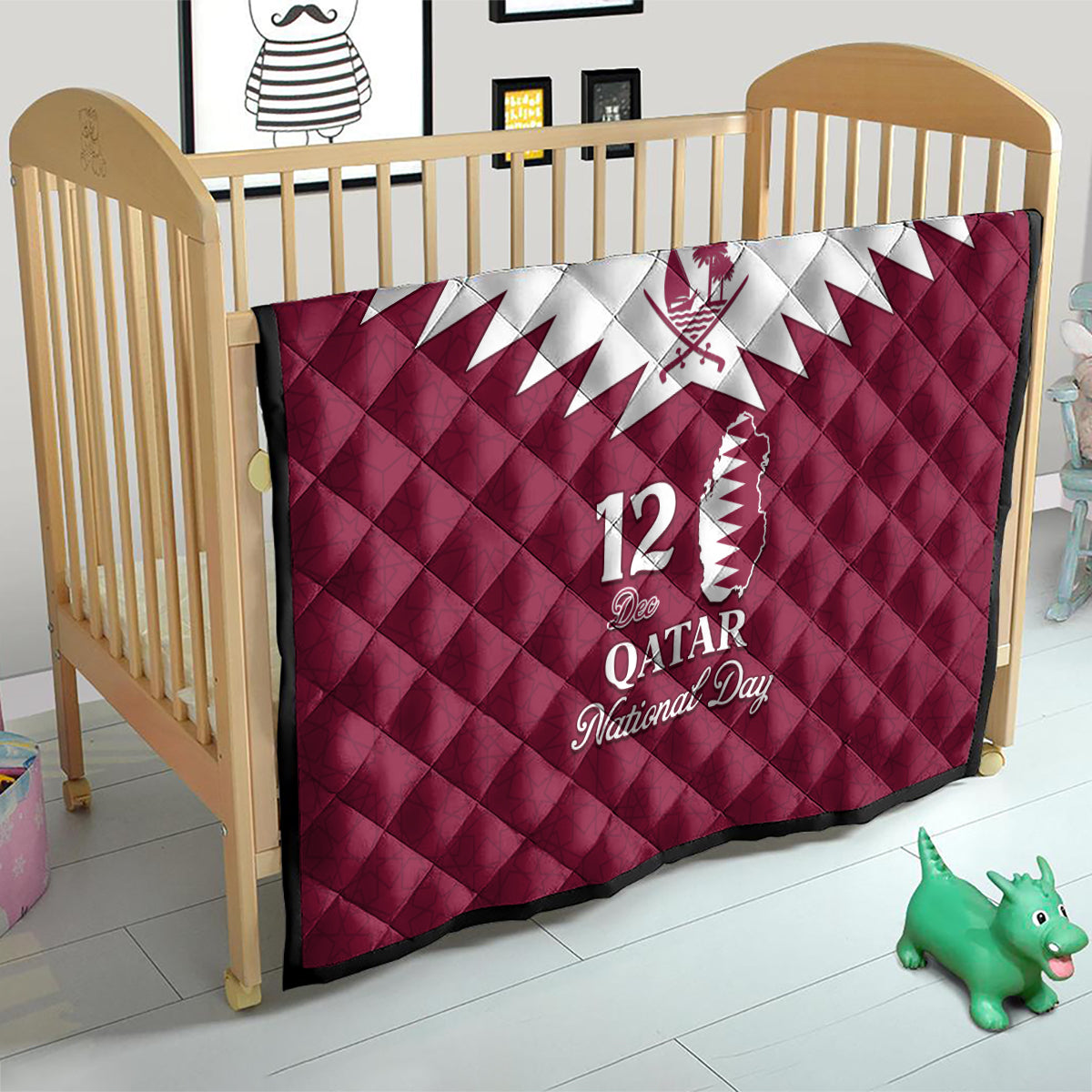 Red quilt blanket in a crib with white Qatar map emblem and “12 Qatar National Day” text