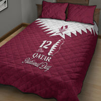 Red quilt bed set on bed, white Qatar map emblem and '12' National Day design with 2 pillows