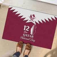 Red rubber doormat with white Qatar map and zigzag border, '12 Dec Qatar National Day'