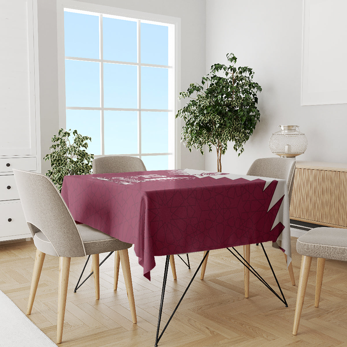 Red rectangular tablecloth with Qatar map and “Qatar National Day” typography on dining set.