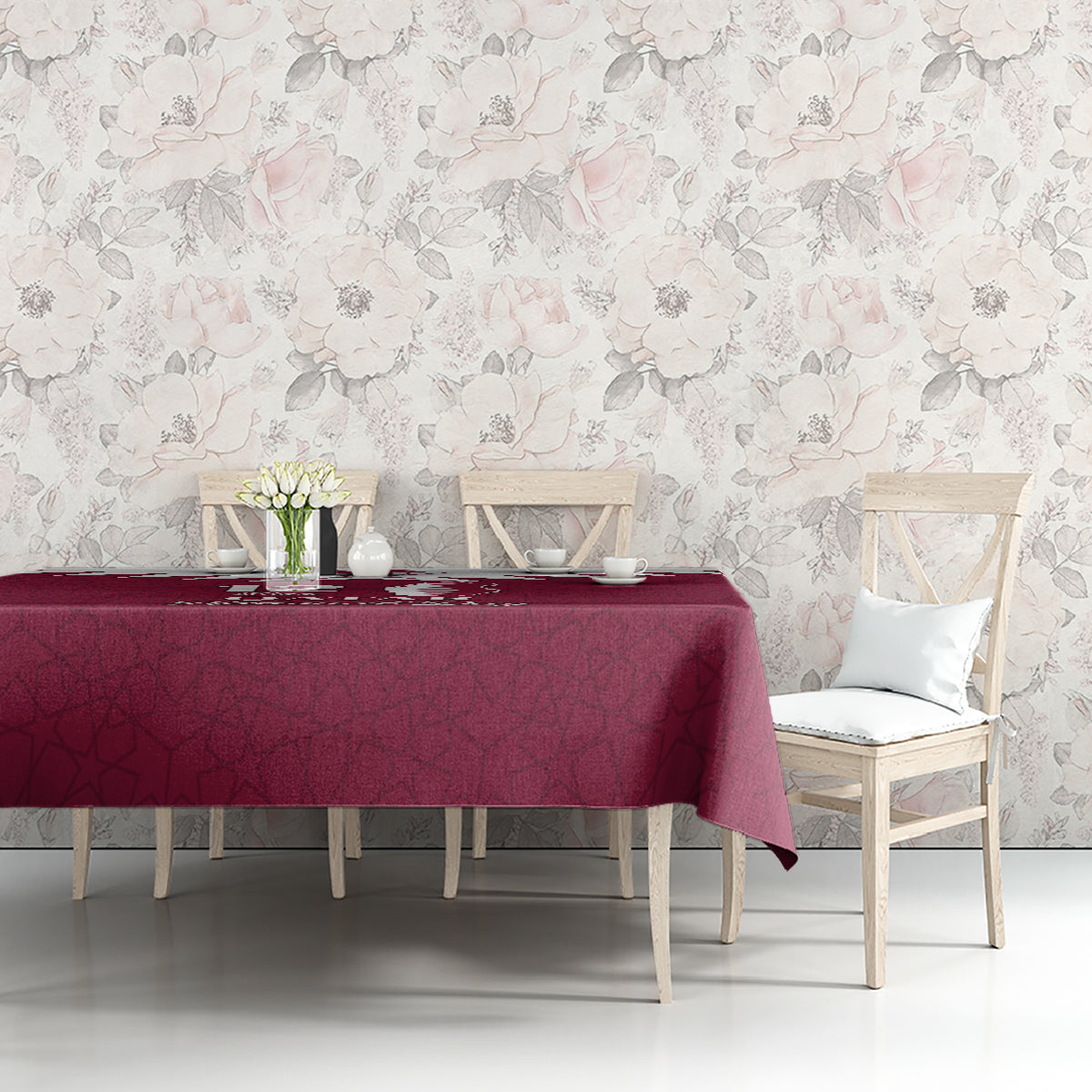 Red tablecloth with Qatar map and Islamic pattern printed over tabletop beside chairs.