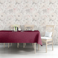 Red tablecloth with Qatar map and Islamic pattern printed over tabletop beside chairs.