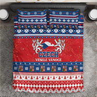 Christmas bedding set with red, blue, and white Czech holiday pattern on a duvet cover.