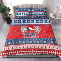 Czech Christmas bedding set on bed with matching red, blue, and white duvet and pillowcases.