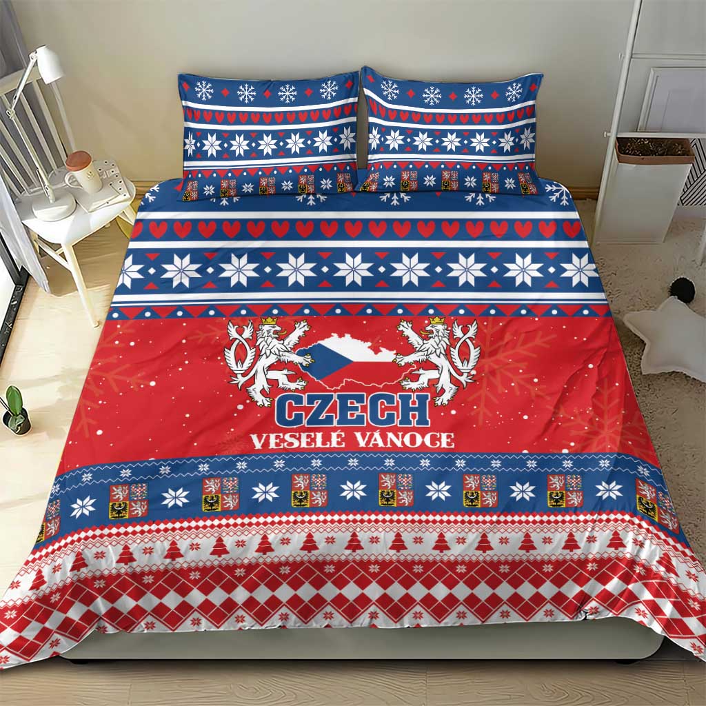 Czech holiday bedding set on bed with red center panel and blue patterned borders.