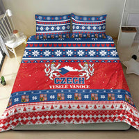 Czech holiday bedding set on bed with red center panel and blue patterned borders.