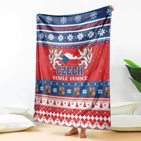 Czech Christmas blanket in red and blue with lion crest and winter motif borders.