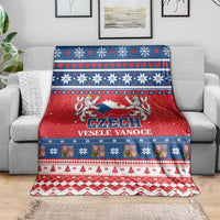 Red and blue Czech Christmas throw blanket with lion emblem, hearts, and snowflake stripes.