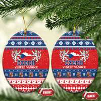 Red ceramic oval Christmas ornament with Czech coat design, blue folk bands, gold loop