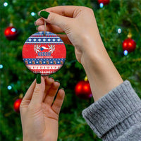 Red ceramic circular Christmas ornament with Czech coat design and blue folk bands, gold loop