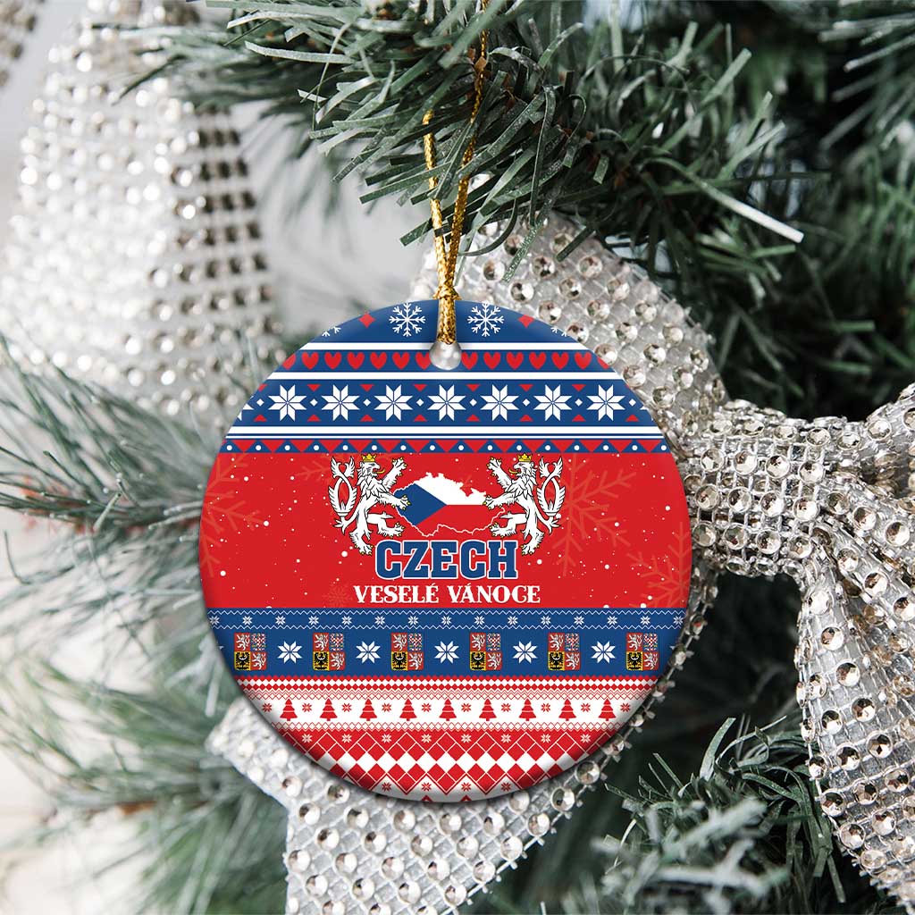 Red ceramic circular Christmas ornament with Czech coat design, blue folk bands, gold hanging loop