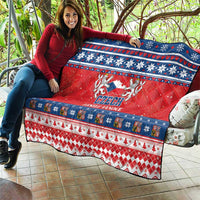 Red Czech Christmas quilt draped on outdoor seat with blue snowflake stripes and emblem