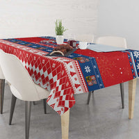 Red Christmas tablecloth with diamond and snowflake motifs over dining table