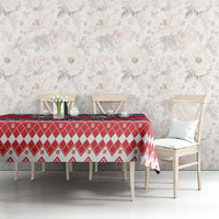 Red Christmas tablecloth with diamond and snowflake motifs on dining table