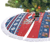 Red and blue round Christmas tree skirt with fringe edge, snowflakes, and striped design