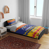Venezuela Christmas bedding set on bed: blue star section with “VENEZUELA” and striped border