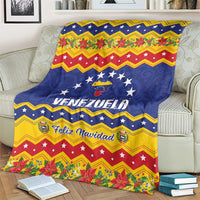 Venezuela Christmas blanket on couch with Venezuela crest and Feliz Navidad lettering