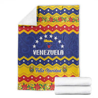 Venezuela Christmas blanket folded with blue stars, yellow trim, and white rolled towels