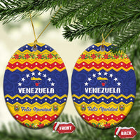 Oval ceramic Venezuela Christmas ornament with blue, red, and yellow Feliz Navidad and gold string