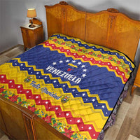 Venezuela Christmas quilt on bed, blue star center with VENEZUELA and Feliz Navidad