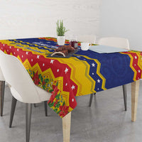 Christmas tablecloth corner showing red, blue, and yellow border with poinsettia print