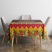 Christmas tablecloth on table with red top panel, blue stripe, and poinsettia border