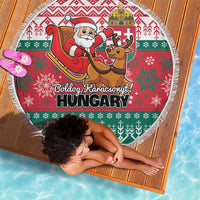 Round Christmas beach blanket with fringe edge, red-green pattern and Santa sleigh graphics