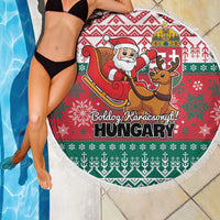 Round fringe-edged Christmas beach blanket in red and green with Santa sleigh and reindeer
