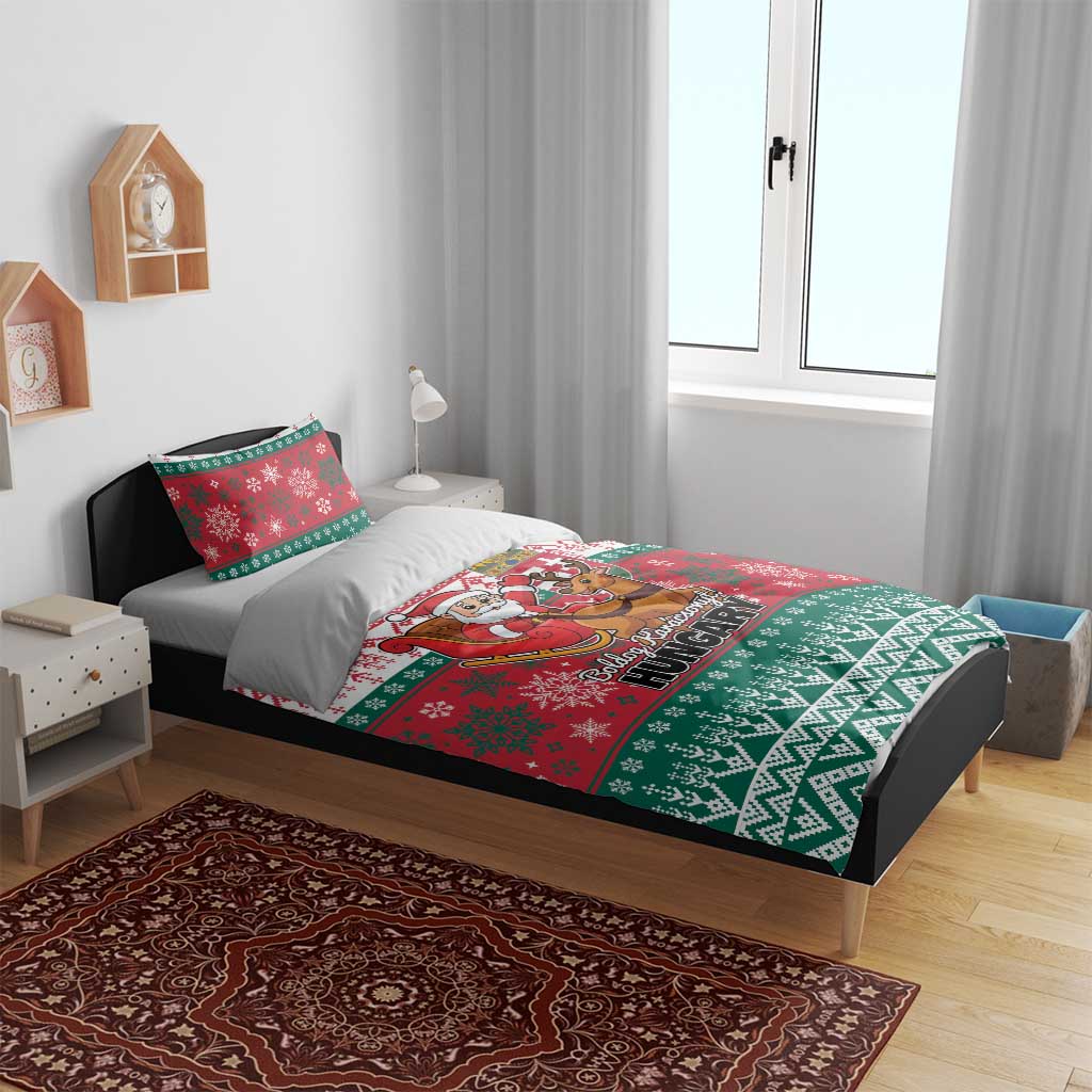 Red and green Christmas duvet with Santa and reindeer, placed on a bed with two pillowcases