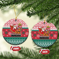 Red and green circular ceramic Christmas ornament with Hungary text and Santa reindeer design.