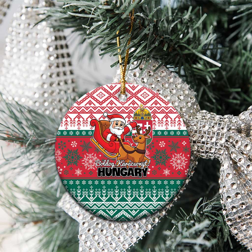 Red and green circular Hungary ceramic Christmas ornament hanging on a tree branch.