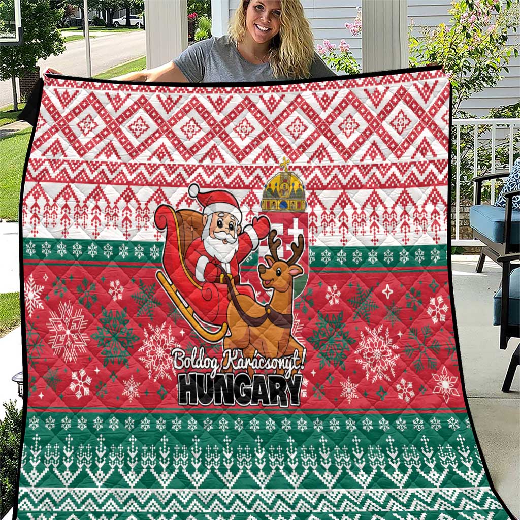 Hungary-themed Christmas quilt draped over a chair, with Santa, reindeer, and red/green patterns.