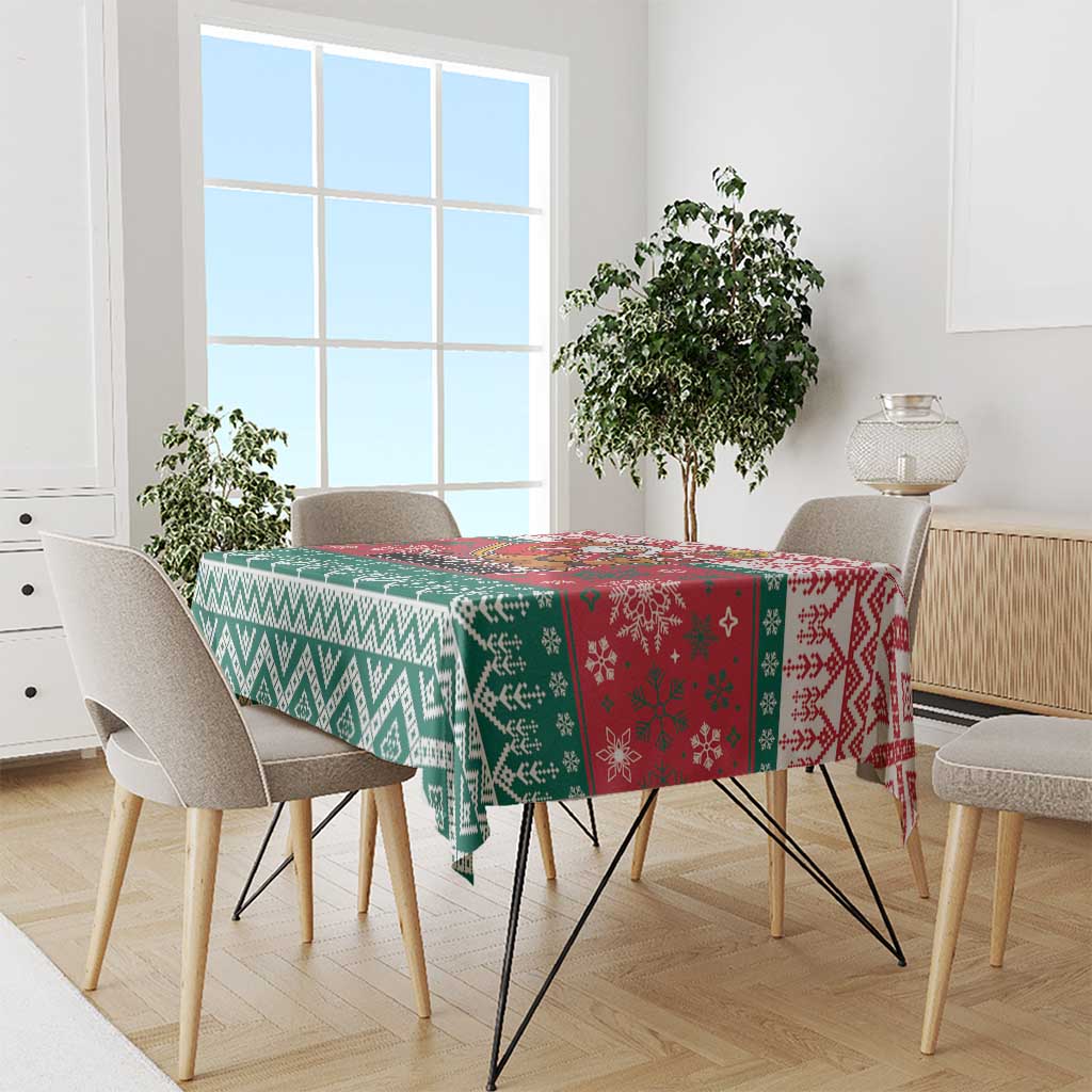 Christmas tablecloth with red, green, and white sections featuring geometric and snowflake motifs.