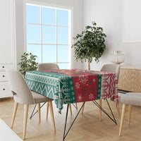 Christmas tablecloth with red, green, and white sections featuring geometric and snowflake motifs.