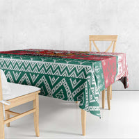 Christmas tablecloth with green and white diamond pattern and a red accent panel on the table.